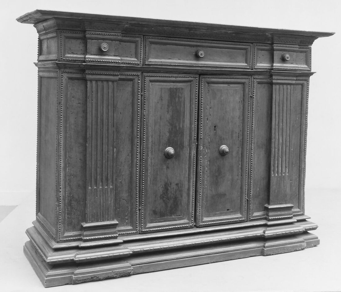Walnut credenza with panelled doors, fluted pilasters and dentilled cornice, Tuscany, second half of the 16th century